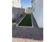 Low maintenance backyard featuring a patch of green turf surrounded by gravel and block fence at 645 N Vine St, Chandler, AZ 85225
