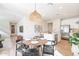 Open-concept dining area adjacent to a kitchen, featuring a stylish light fixture and seating for four at 645 N Vine St, Chandler, AZ 85225