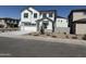 Charming two-story home with white stucco and dark trim, complemented by a landscaped front yard at 645 N Vine St, Chandler, AZ 85225