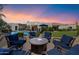 Picturesque backyard featuring a cozy seating area with fire pit, pool and elegant landscaping at 7002 E Aster Dr, Scottsdale, AZ 85254