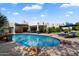 Beautiful backyard featuring a pool, covered patio, outdoor kitchen, and lush landscaping for relaxation and entertaining at 7002 E Aster Dr, Scottsdale, AZ 85254
