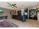 Charming bar area featuring custom cabinetry, pendant lighting, and a wine fridge for the discerning host at 7002 E Aster Dr, Scottsdale, AZ 85254