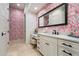 Elegant bathroom featuring stylish wallpaper, dual sink vanity, and ample storage space for a luxurious retreat at 7002 E Aster Dr, Scottsdale, AZ 85254