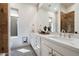 Bright bathroom featuring double vanity with marble countertop and stylish tile flooring and a walk-in shower at 7002 E Aster Dr, Scottsdale, AZ 85254