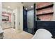 Bright bathroom featuring a glass shower, soaking tub, and patterned wallpaper at 7002 E Aster Dr, Scottsdale, AZ 85254