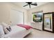 Cozy bedroom featuring a twin bed with decorative pillows, a dresser with TV, and a large mirror at 7002 E Aster Dr, Scottsdale, AZ 85254