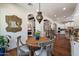 Open dining area with wooden floors, ornate chairs, and views into the kitchen and living spaces at 7002 E Aster Dr, Scottsdale, AZ 85254