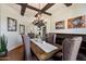 Beautiful dining room with exposed beams, elegant chandelier, and decorative art throughout at 7002 E Aster Dr, Scottsdale, AZ 85254