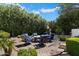 Cozy fire pit area with comfortable seating nestled amidst lush landscaping for outdoor relaxation at 7002 E Aster Dr, Scottsdale, AZ 85254