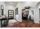 Inviting foyer featuring hardwood floors, decorative art, and access to the formal dining room at 7002 E Aster Dr, Scottsdale, AZ 85254