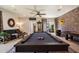 Entertaining game room boasts a billiards table, lounge area, and seamless indoor-outdoor flow to a cozy patio at 7002 E Aster Dr, Scottsdale, AZ 85254
