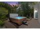Inviting backyard hot tub with lush landscaping offers a private and relaxing retreat at 7002 E Aster Dr, Scottsdale, AZ 85254