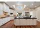 Well-lit kitchen boasts white cabinets, modern appliances, a central island, and a bright window at 7002 E Aster Dr, Scottsdale, AZ 85254