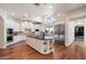 Spacious kitchen with white cabinetry, a central island, stainless appliances, and a sunlit window at 7002 E Aster Dr, Scottsdale, AZ 85254