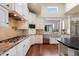 Close-up of a kitchen with stainless steel appliances, white cabinets, and granite countertops at 7002 E Aster Dr, Scottsdale, AZ 85254