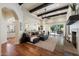 Open-concept living room with exposed beams, hardwood floors, and easy access to the outdoor pool area at 7002 E Aster Dr, Scottsdale, AZ 85254