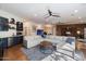 Spacious living room featuring a sectional sofa, wet bar, and brick accent wall at 7002 E Aster Dr, Scottsdale, AZ 85254