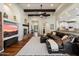 Cozy living room with a fireplace, hardwood floors, and an open layout to the kitchen and dining areas at 7002 E Aster Dr, Scottsdale, AZ 85254