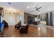 Open living room featuring brick accent wall, hardwood floors, and large window at 7002 E Aster Dr, Scottsdale, AZ 85254