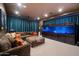 Media room with a large saltwater aquarium, comfortable sectional sofa, and dimmable recessed lighting at 7002 E Aster Dr, Scottsdale, AZ 85254