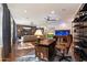 Spacious living room featuring a desk and chair, brick accent wall, and hardwood floors at 7002 E Aster Dr, Scottsdale, AZ 85254