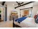 Relaxing primary bedroom with exposed beam ceilings, decorative furniture, and plenty of natural light at 7002 E Aster Dr, Scottsdale, AZ 85254