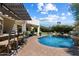 Relaxing backyard pool with patio, lounge chairs, and lush landscaping offering a private retreat at 7002 E Aster Dr, Scottsdale, AZ 85254