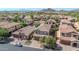 An elevated aerial view showcases the terra cotta roofs of single-Gathering homes nestled in a desert community at 7252 E Nance St, Mesa, AZ 85207