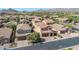 Elevated aerial view of houses in a desert community, showcasing terra cotta roofs and desert landscaping at 7252 E Nance St, Mesa, AZ 85207