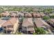 An aerial view of a home with a large patio, set amid other homes with well-maintained tile roofs at 7252 E Nance St, Mesa, AZ 85207
