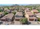 Expansive aerial view of single-Gathering homes featuring terra cotta roofs in a desert community with mountain views at 7252 E Nance St, Mesa, AZ 85207