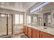 Bright bathroom with a separate shower and tub, dual sinks, and shuttered windows at 7252 E Nance St, Mesa, AZ 85207