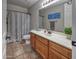 Well-lit bathroom with a tub-shower combination and vanity featuring a wooden cabinet at 7252 E Nance St, Mesa, AZ 85207