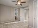 Bedroom with tile flooring, ceiling fan, and adjoining bathroom and closet at 7252 E Nance St, Mesa, AZ 85207