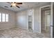 Bright bedroom features tiled flooring, ceiling fan and plantation shutters at 7252 E Nance St, Mesa, AZ 85207