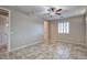 Cozy bedroom with tile flooring, a ceiling fan, and access to other rooms at 7252 E Nance St, Mesa, AZ 85207