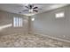 Bright bedroom featuring tile flooring, a ceiling fan, and shuttered windows at 7252 E Nance St, Mesa, AZ 85207