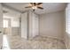 Bedroom features tiled flooring, ceiling fan, and closet with sliding doors at 7252 E Nance St, Mesa, AZ 85207