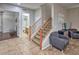 Charming entryway featuring tile flooring, staircase to the second level, and access to the downstairs bathroom at 7252 E Nance St, Mesa, AZ 85207