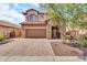 Charming two-story home with brick driveway and walkway and stone accents for inviting curb appeal at 7252 E Nance St, Mesa, AZ 85207