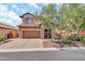Charming two-story home features a two-car garage, brick driveway, and a beautifully landscaped front yard at 7252 E Nance St, Mesa, AZ 85207