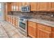 Close-up of a kitchen area with granite countertops, stainless steel appliances, and custom cabinets at 7252 E Nance St, Mesa, AZ 85207
