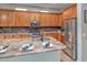 Kitchen island with granite countertops, stainless steel appliances, and a breakfast bar at 7252 E Nance St, Mesa, AZ 85207