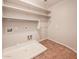 Laundry room includes utility sink, shelving and hookups for washer/dryer at 7252 E Nance St, Mesa, AZ 85207