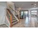 Bright and airy living area with tile flooring, staircase to the second level, and access to outdoor spaces at 7252 E Nance St, Mesa, AZ 85207