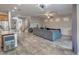 Open-concept living space with tile floors, gray sofa, stairs to the upper level, and kitchen access at 7252 E Nance St, Mesa, AZ 85207
