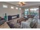 Cozy living area with neutral colors, a ceiling fan, and sliding door access to the outdoor living space at 7252 E Nance St, Mesa, AZ 85207