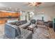 Open-concept living room featuring tile flooring, a comfortable leather sectional, and a ceiling fan at 7252 E Nance St, Mesa, AZ 85207