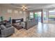 Inviting living area featuring tile floors, natural light, and views of the back patio through large windows at 7252 E Nance St, Mesa, AZ 85207