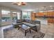Open-concept living space featuring tile flooring, outdoor access, and kitchen with island at 7252 E Nance St, Mesa, AZ 85207
